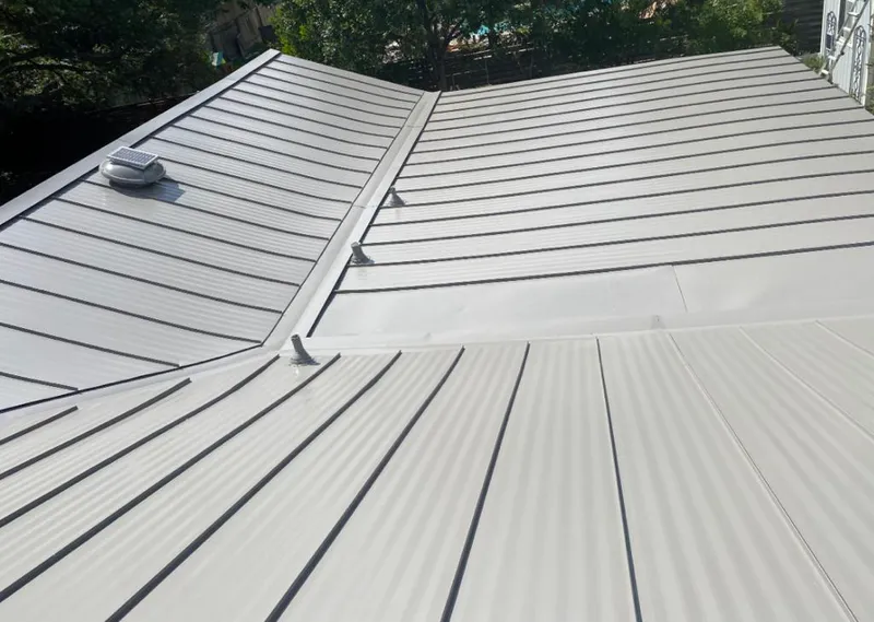 Solar attic fan installed on a metal roof for Roof Ventilation in Watauga